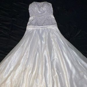 White strapless glittery gown with jewels sewn on top half.